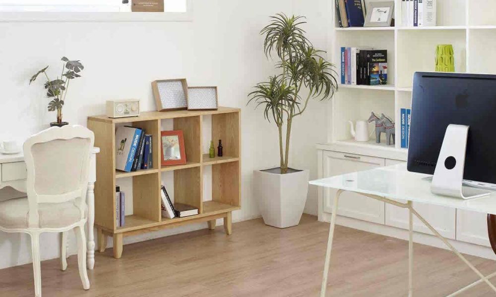 <span class="uk-h4">A home office with a white desk, a computer, bookshelves, and decorative plants, providing a clean and organized workspace.</span>