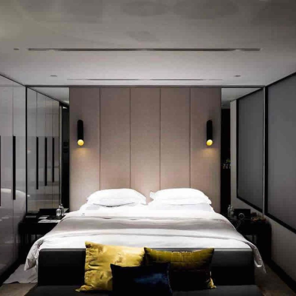 <span class="uk-h4">A contemporary bedroom with a large bed, minimalistic decor, and soft lighting, creating a serene and restful space.</span>